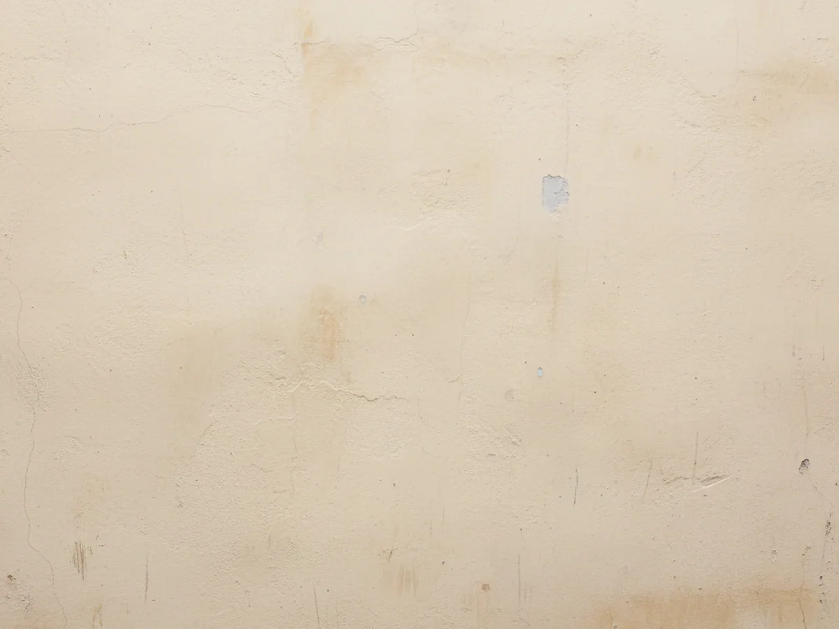 A plain rendered wall face in warm off-white